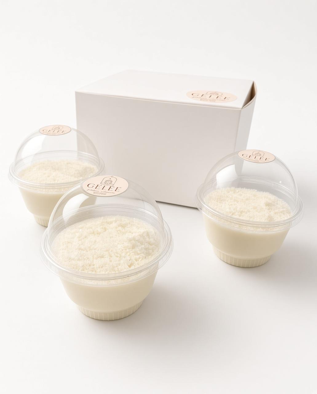 Tres gelatinas GELÉE sabor coco con coco rallado, junto a su caja
